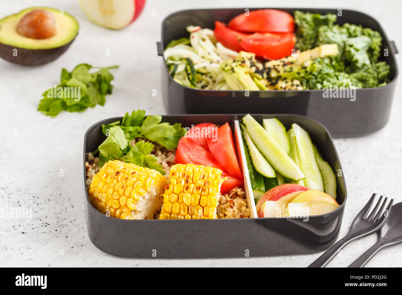 Healthy meal prep containers with quinoa, avocado, corn, zucchini