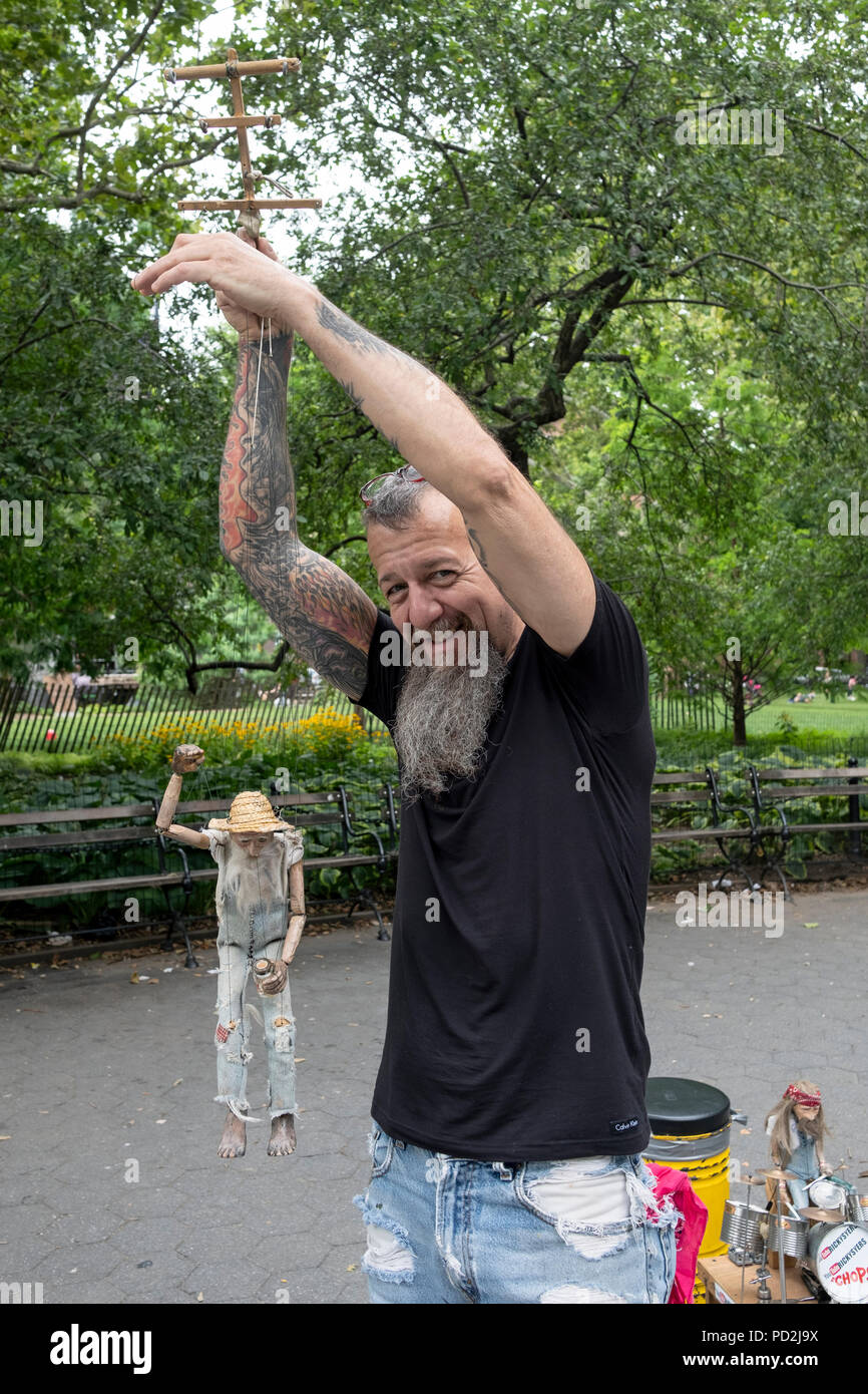 Marionettist Ricky Syers and his marionette Chops Sawyer the drummer performing in Washington Square Park in Greenwich Village, New York City. Stock Photo