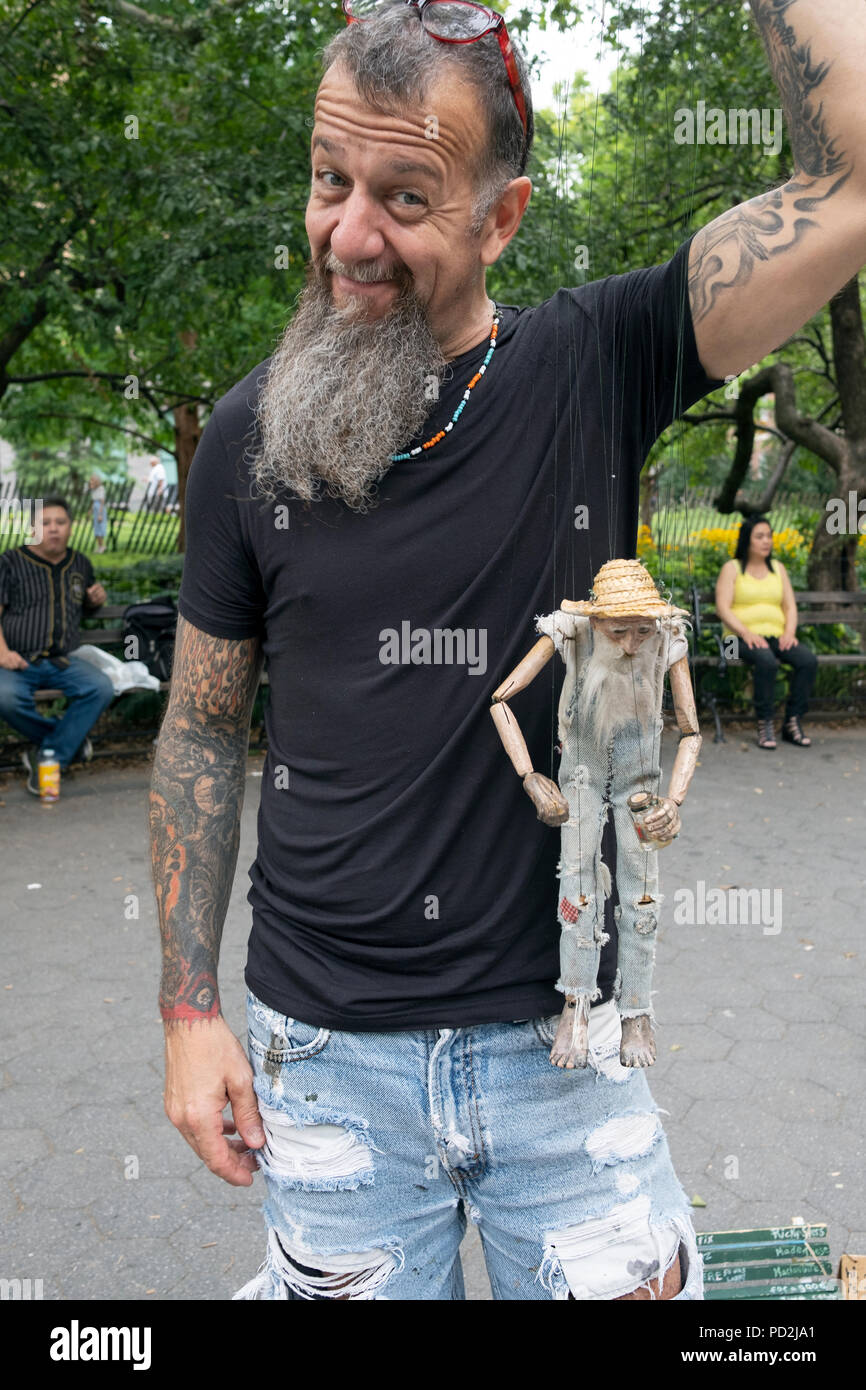Posed portrait of marionettist Ricky Syers and his marionette in Washington Square Park in Greenwich Village, New York City. Stock Photo