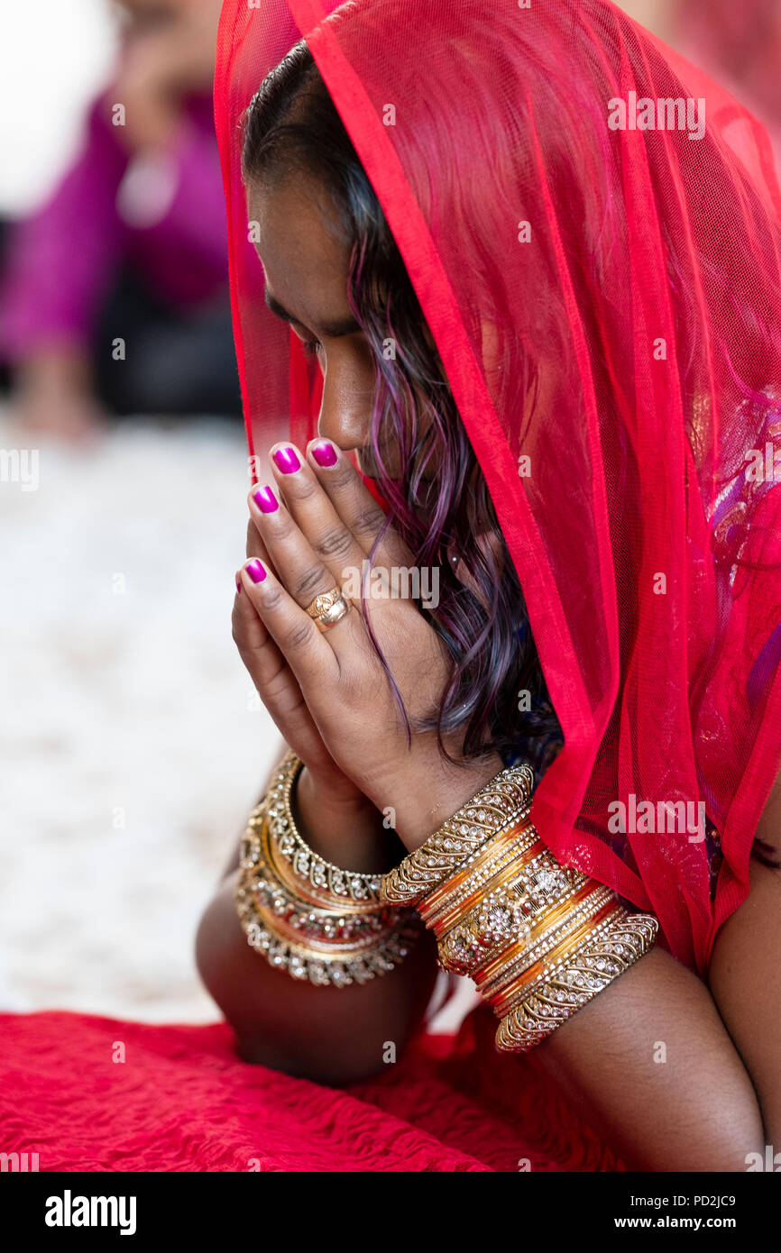 Portrait of a Guyanese woman with many many bracelets worshipping at the Tulsi Mandir in South Richmond Hill, Queens, New York Stock Photo
