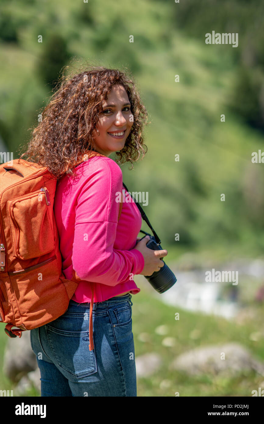 Young tourist woman taking a photo of landscape. Stock Photo
