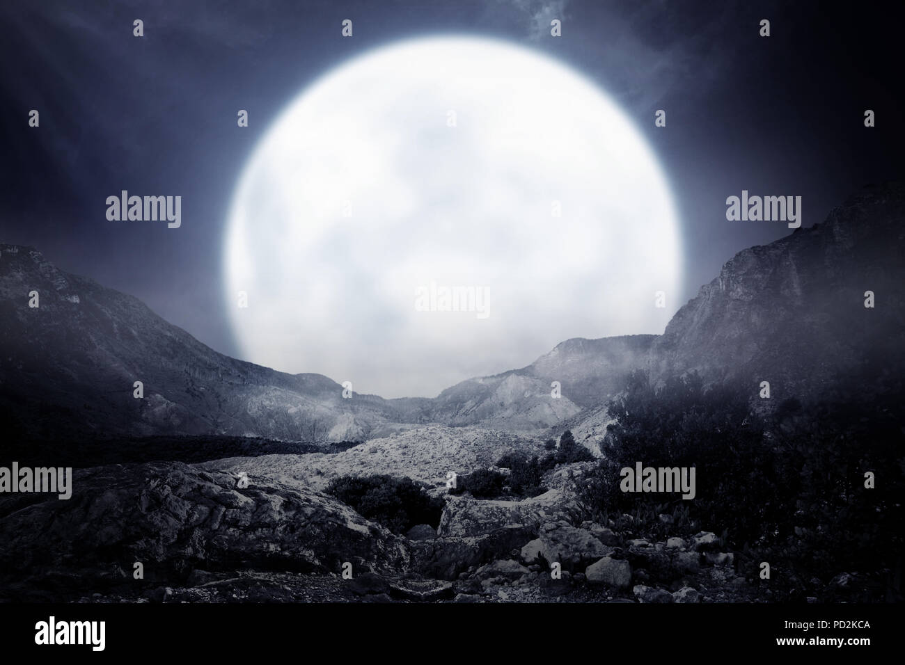 Foggy rocky mountain with moonlight background Stock Photo - Alamy