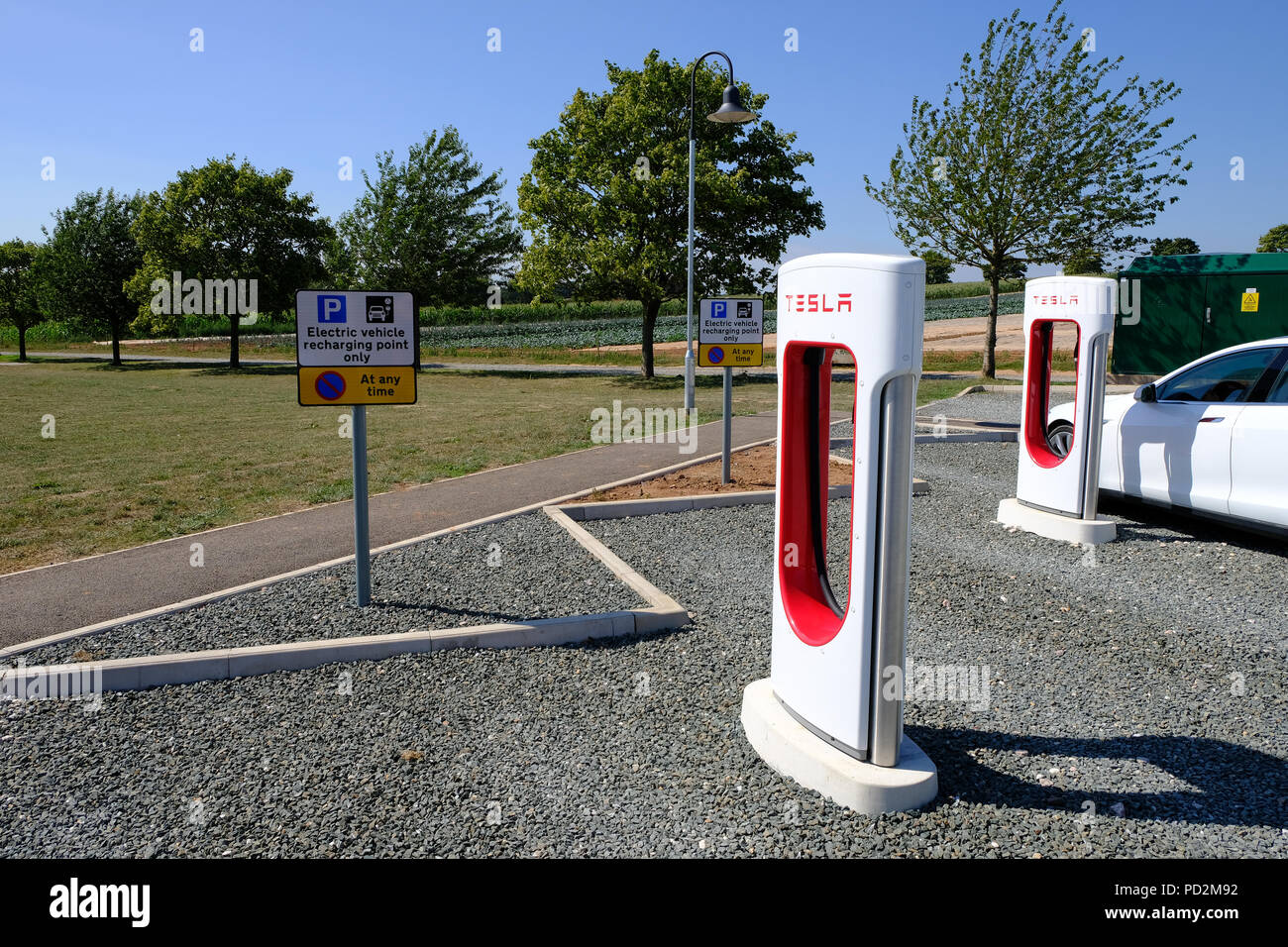 Topsham, Devon, UK. Tesla supercharger station located in Darts Farm Stock Photo