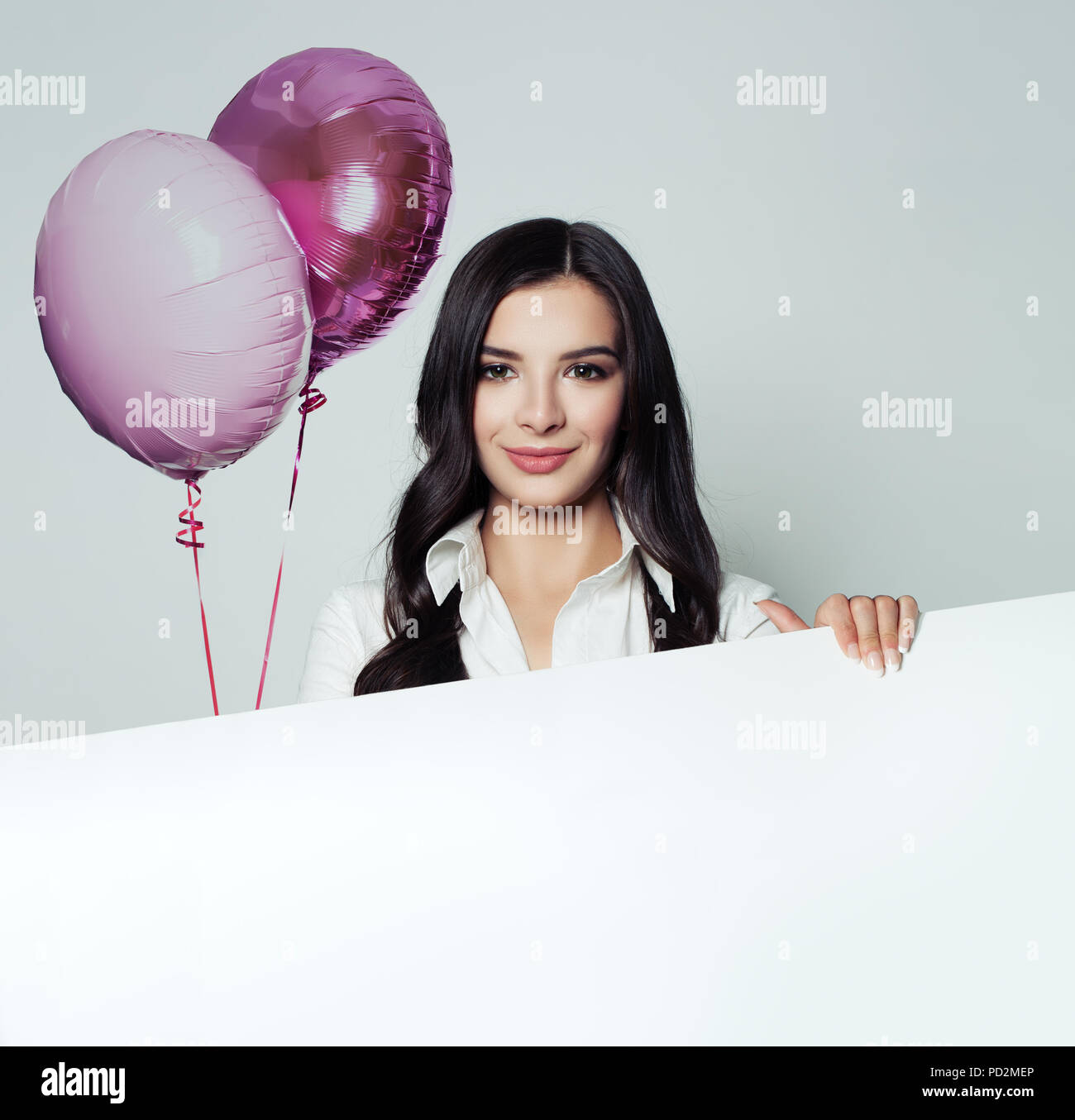 Business woman with white blank paper banner background and pink balloons Stock Photo