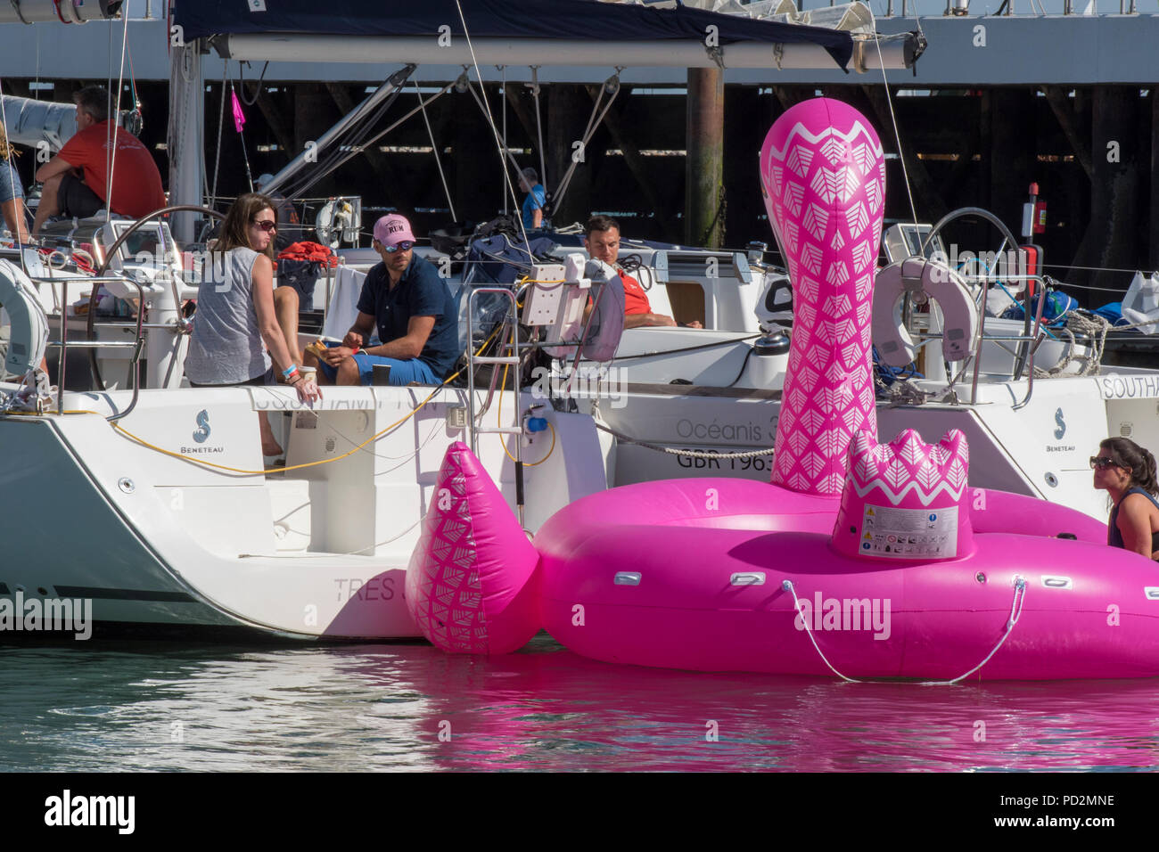 a large seaside inflatable toy tied to the back of a yacht for a bit of fun duting the annual cowes week regatta on the isle of wight Stock Photo