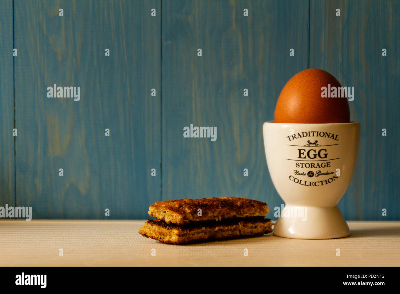 Boiled egg in an egg cup with toast soldiers Stock Photo Alamy