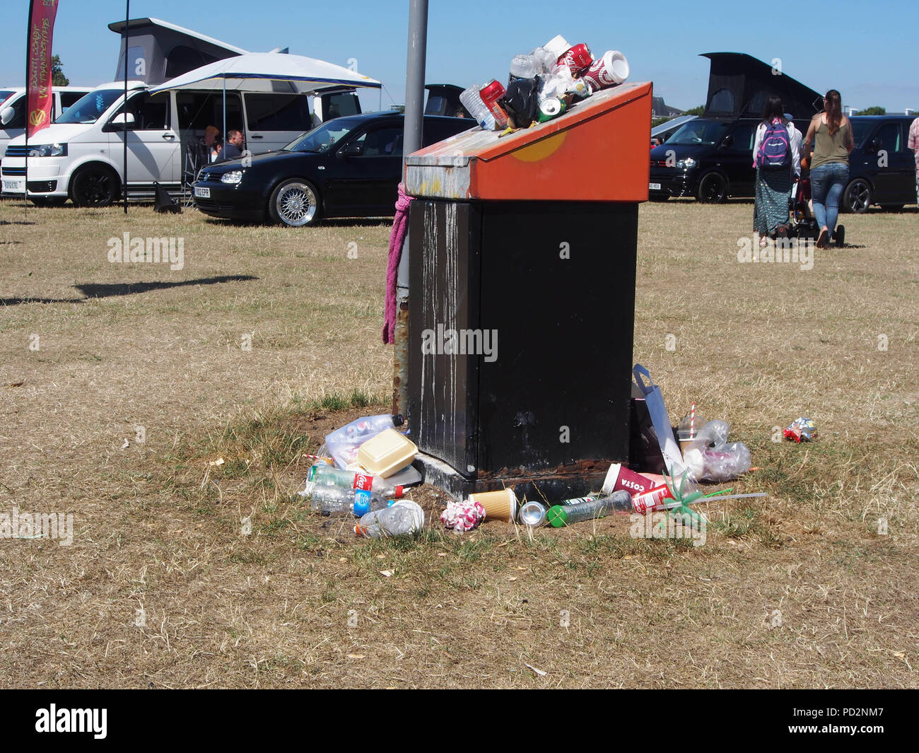 An overflowing runnish bin in  public area Stock Photo
