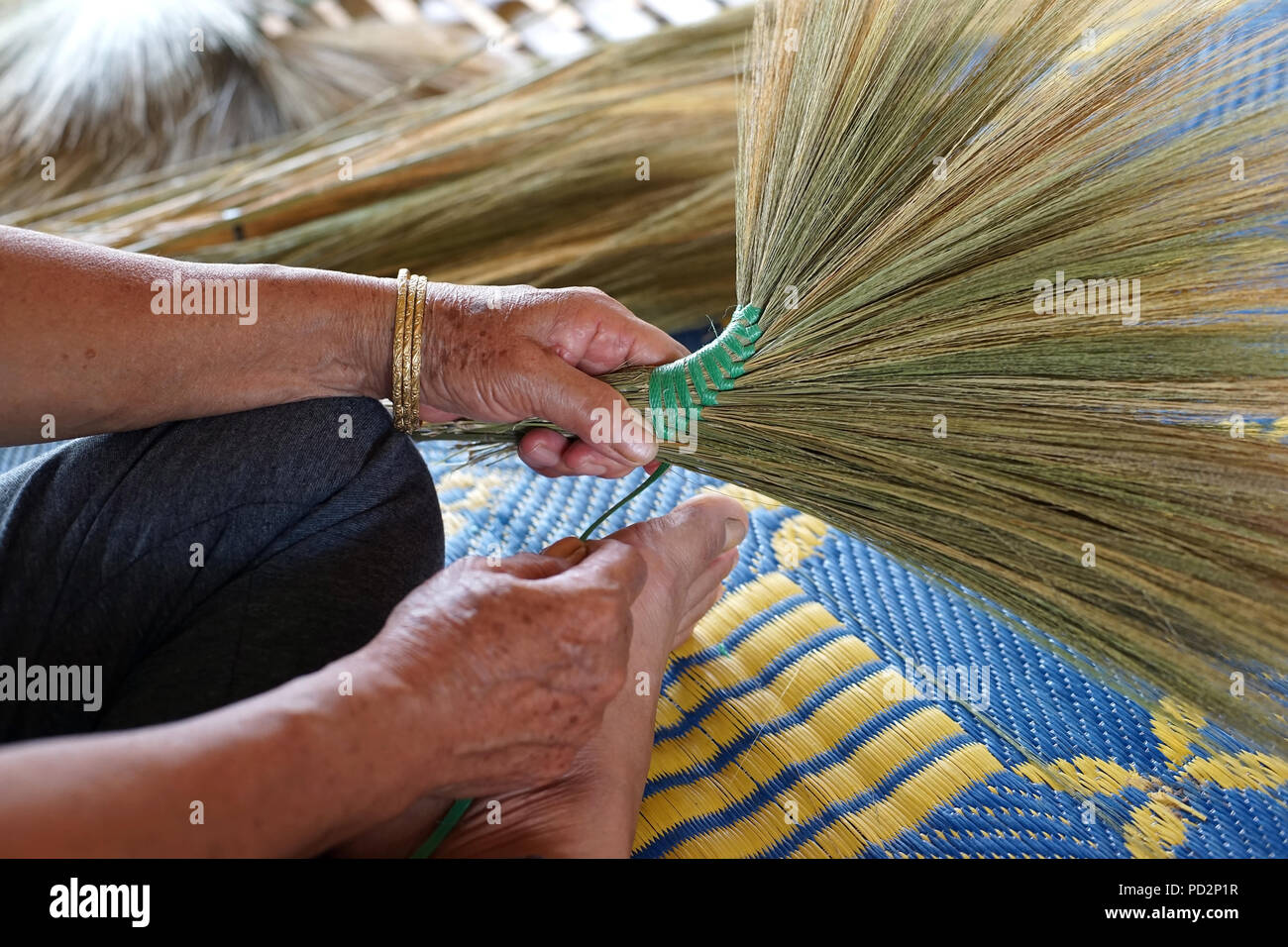 photo of women's hand is making thai broom Stock Photo