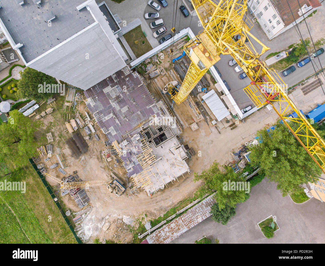 yellow tower crane for construction of new high-rise apartment building. aerial top view Stock Photo
