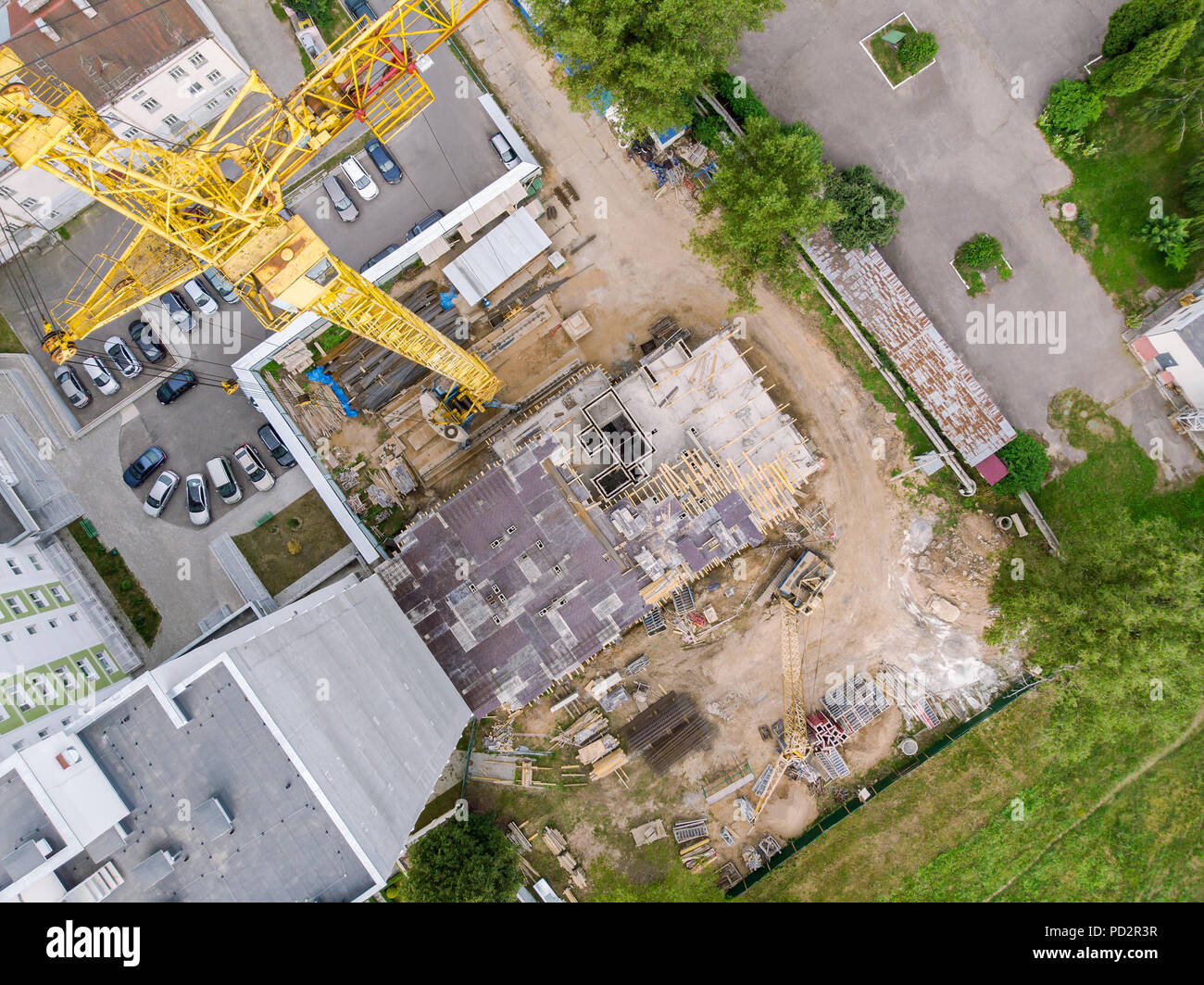 construction site in progress. top aerial view of building under construction and tower crane Stock Photo