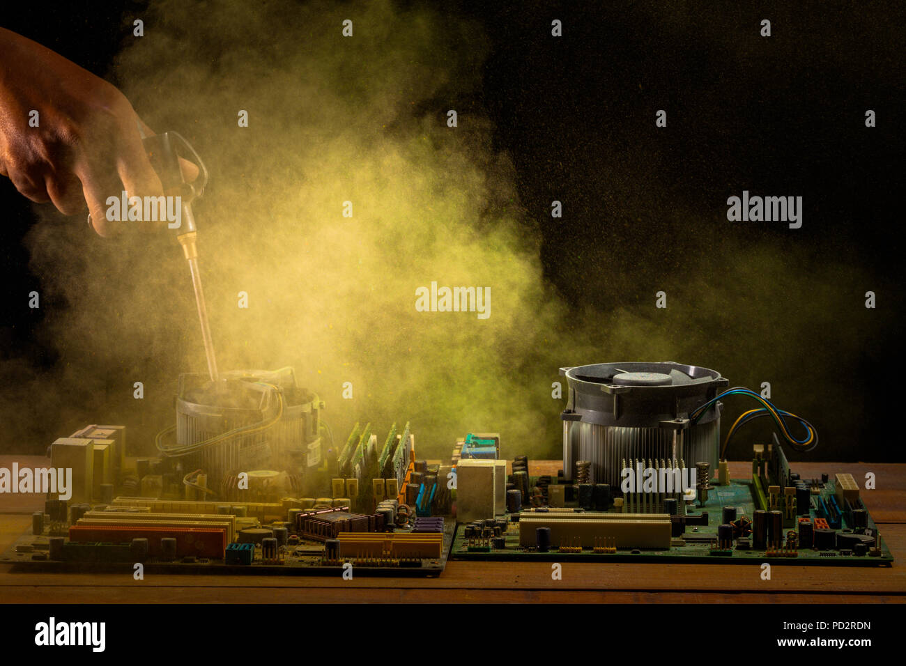 computer mainboard on wooden table on black background. using air