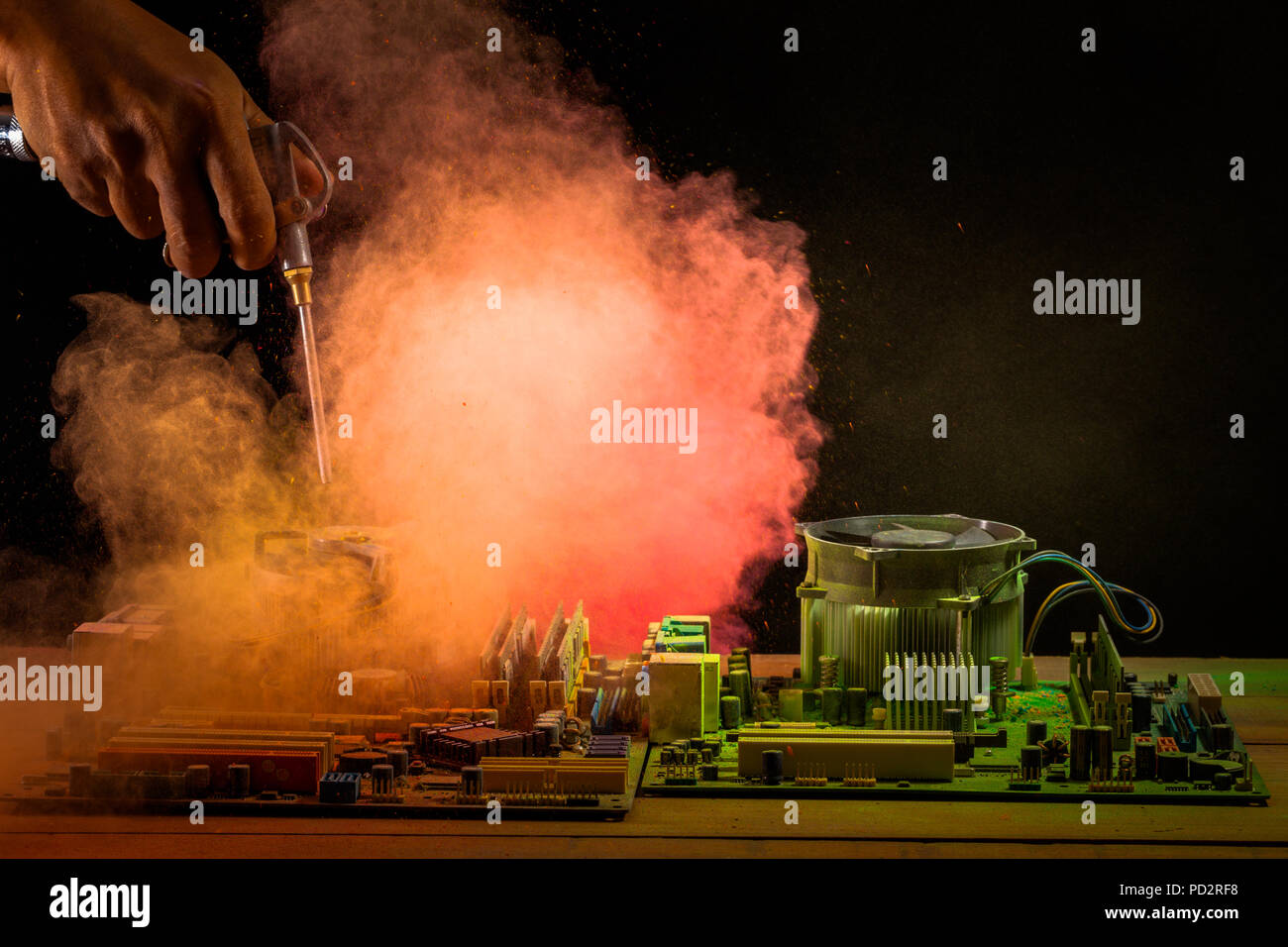 computer mainboard on wooden table on black background. using air