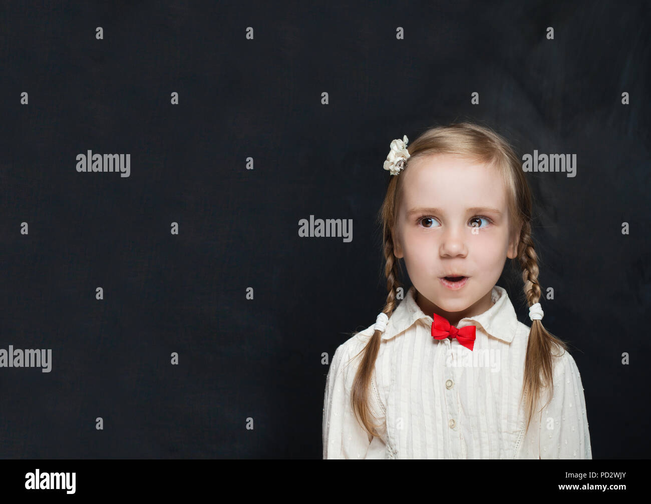 Surprised Child Pupil on School Background Stock Photo