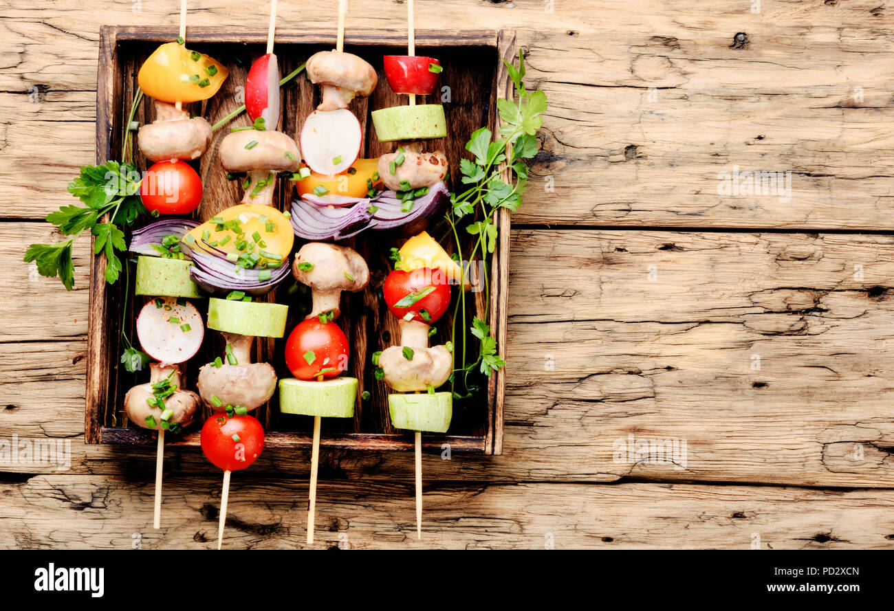 Grilled vegetable kebabs on skewers with tomato, pepper, mushrooms