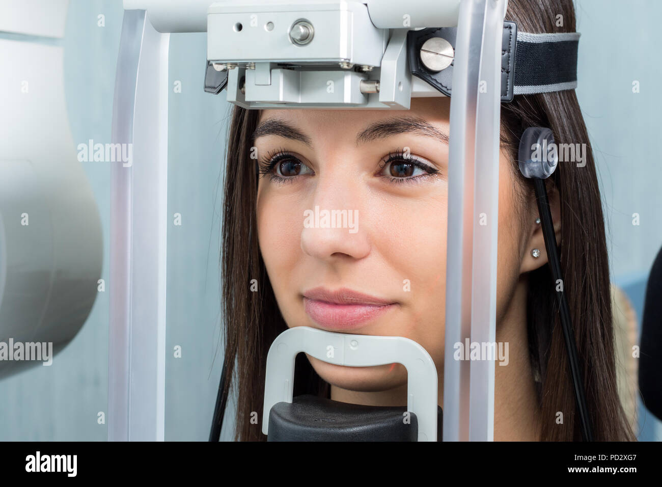 Close up face shot of girl with head positioned in cephalometric panorama x-ray machine. Stock Photo