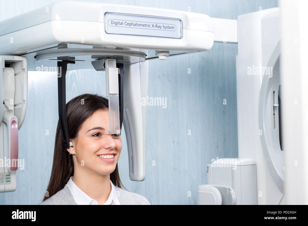 Close up of girl in 3d digital cephalometric panorama x-ray machine in clinic. Woman having dental tac taken. Stock Photo