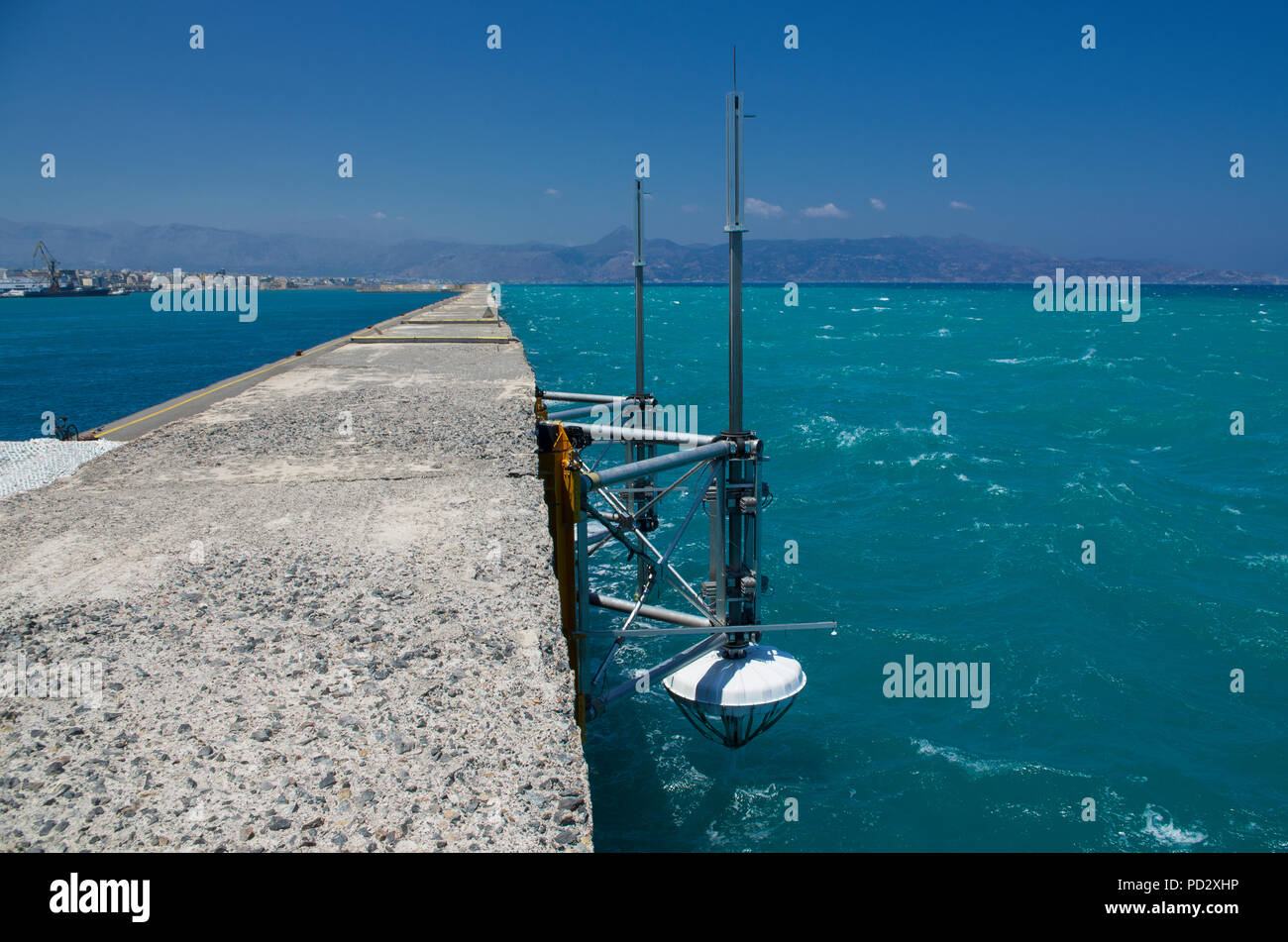 Seascape with Marine research equipment fixed on the concrete pier of Heraklion in Greece in the summer season Stock Photo