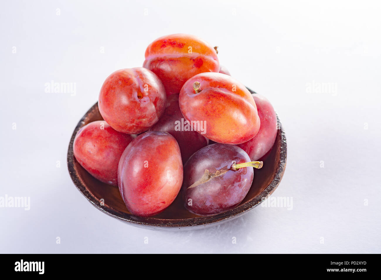 Group of ripe oval Victoria plums from England on white background with