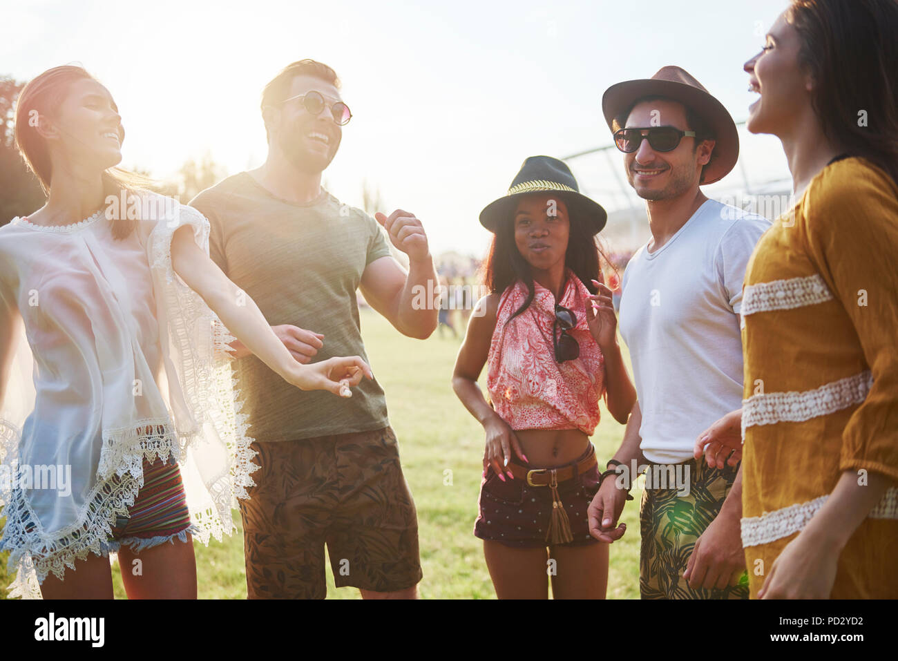 Five young adult friends dancing and having fun at Holi Festival Stock Photo