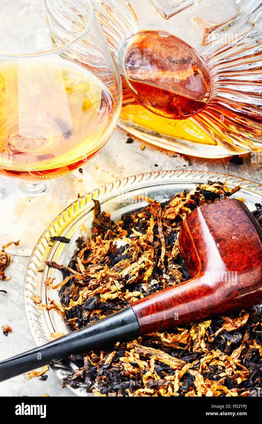 Glass of cognac and pipe with tobacco Stock Photo Alamy