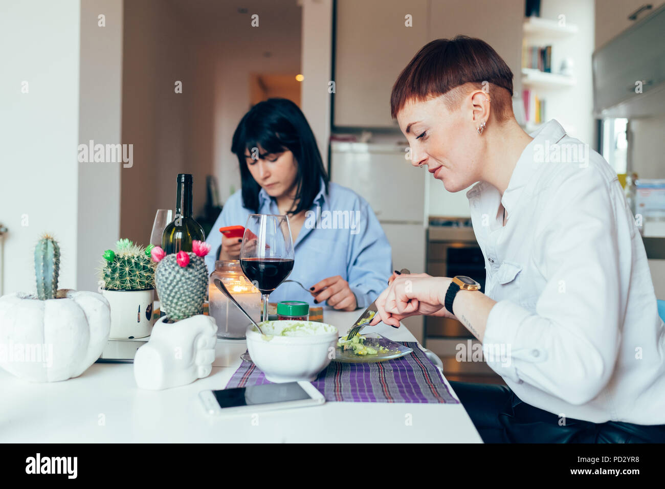 Women at home dining at table Stock Photo