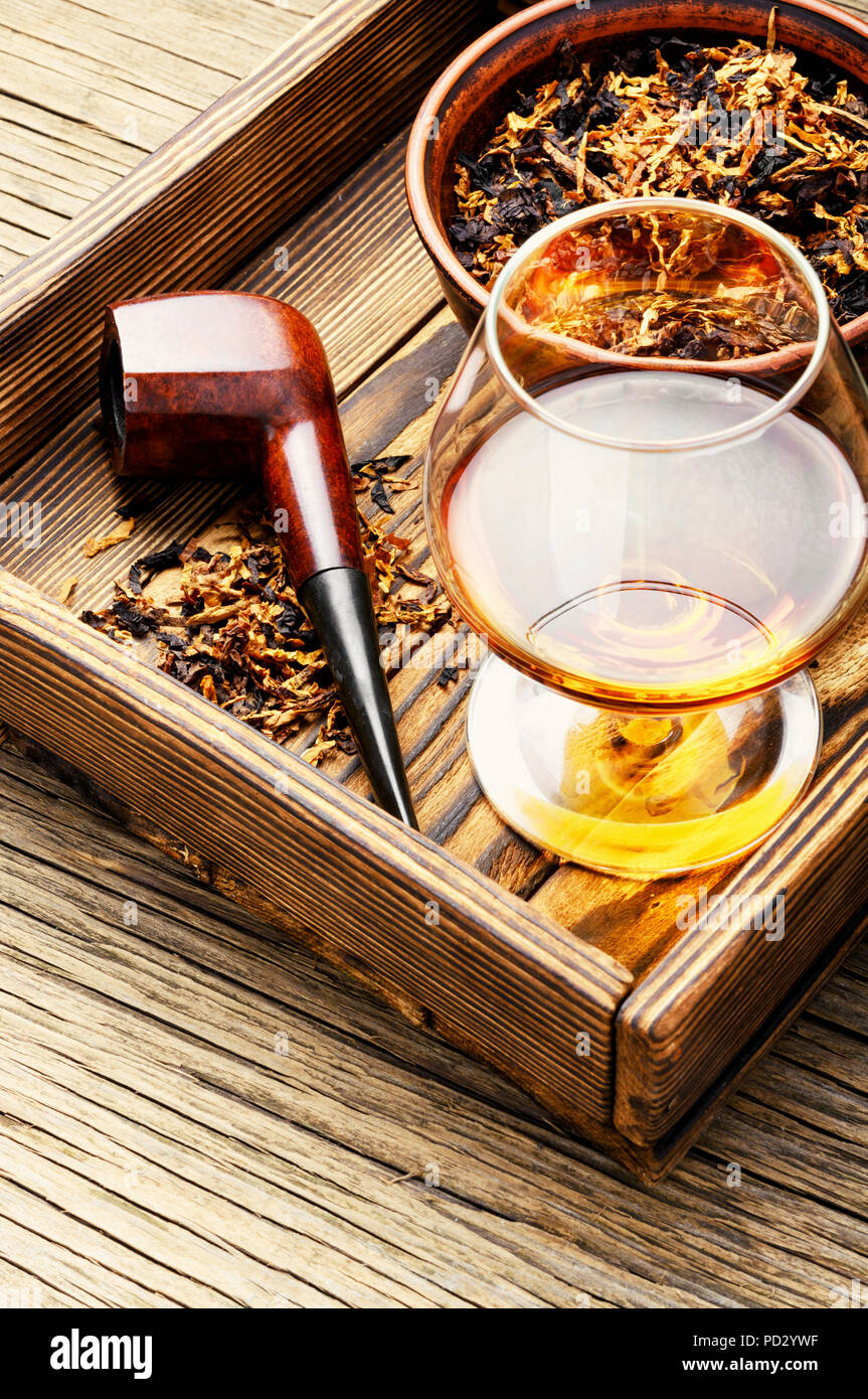 Glass of cognac and pipe with tobacco Stock Photo Alamy