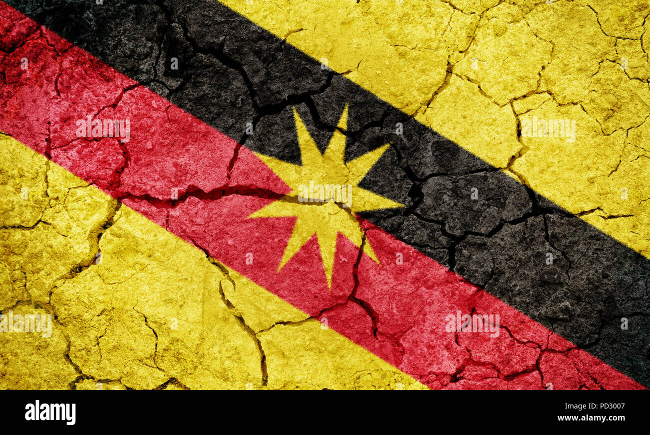 Sarawak, state of Malaysia, flag on dry earth ground texture background Stock Photo