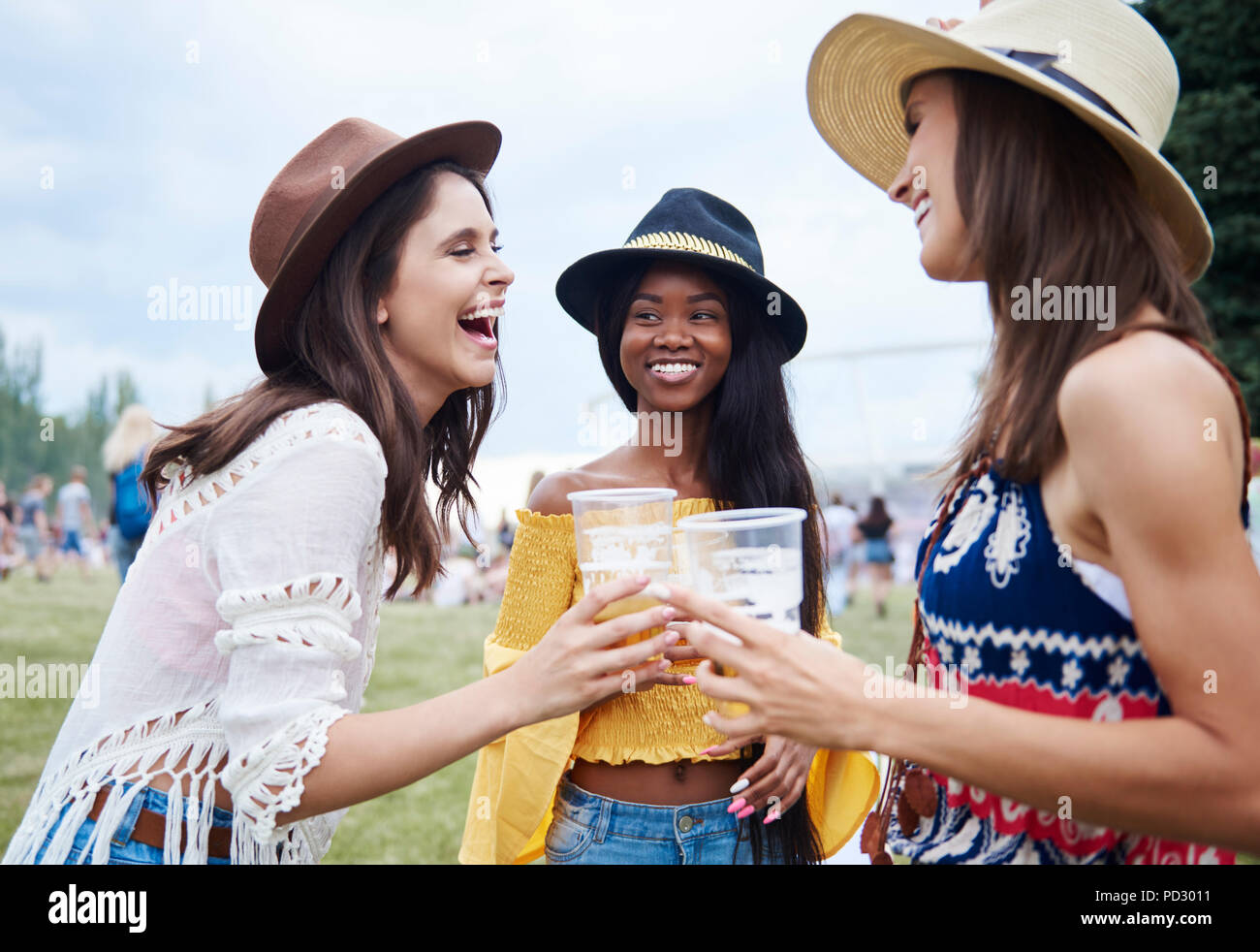 Friends drinking in music festival Stock Photo