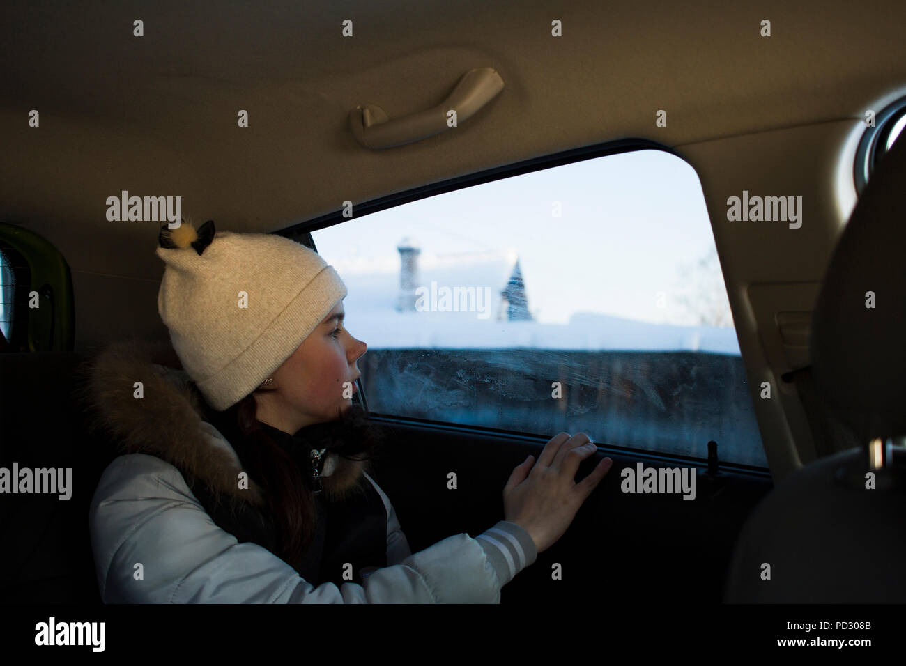 Girl looking out of car window Stock Photo