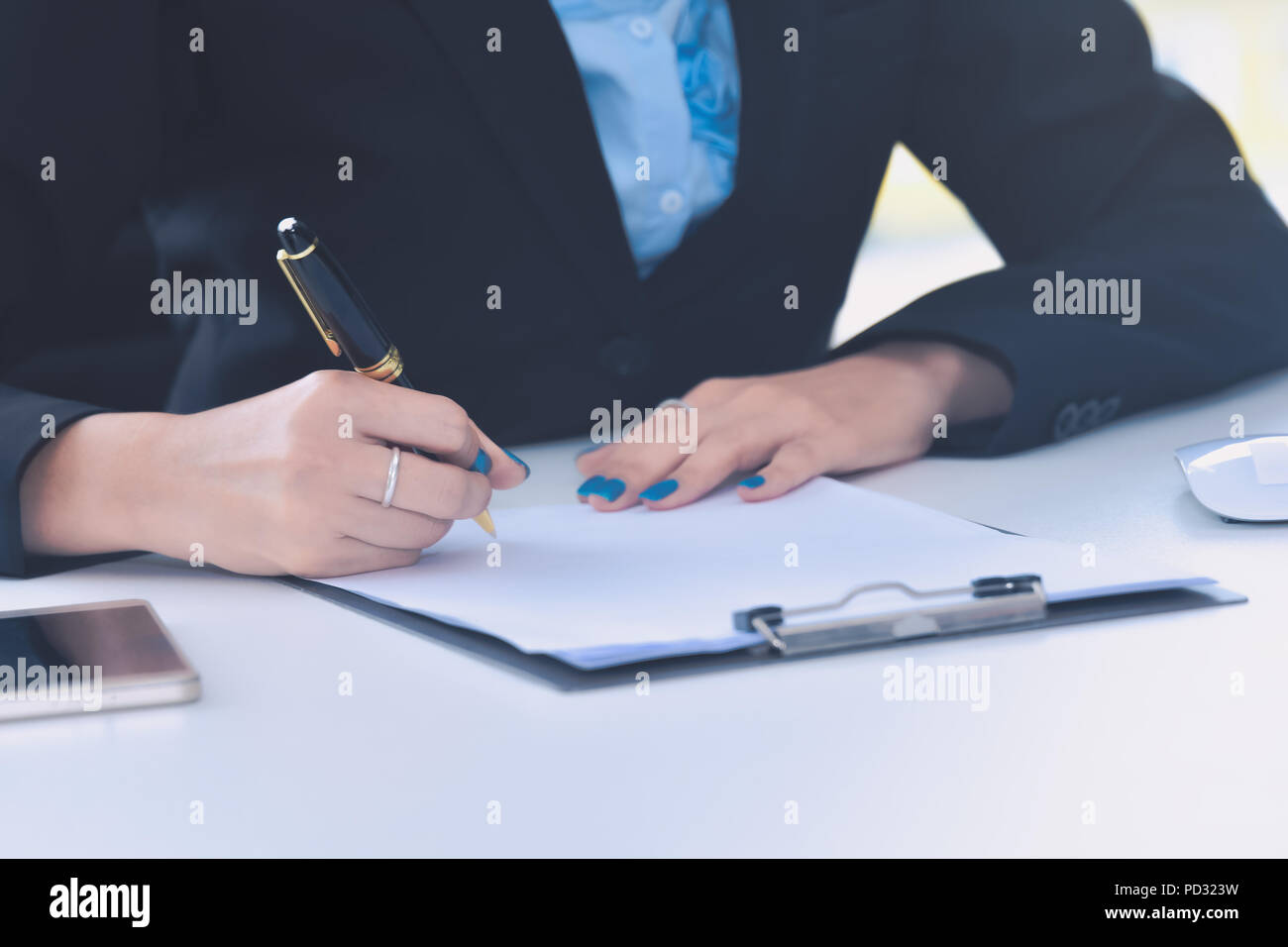 Close up business woman hand signing contract document Stock Photo