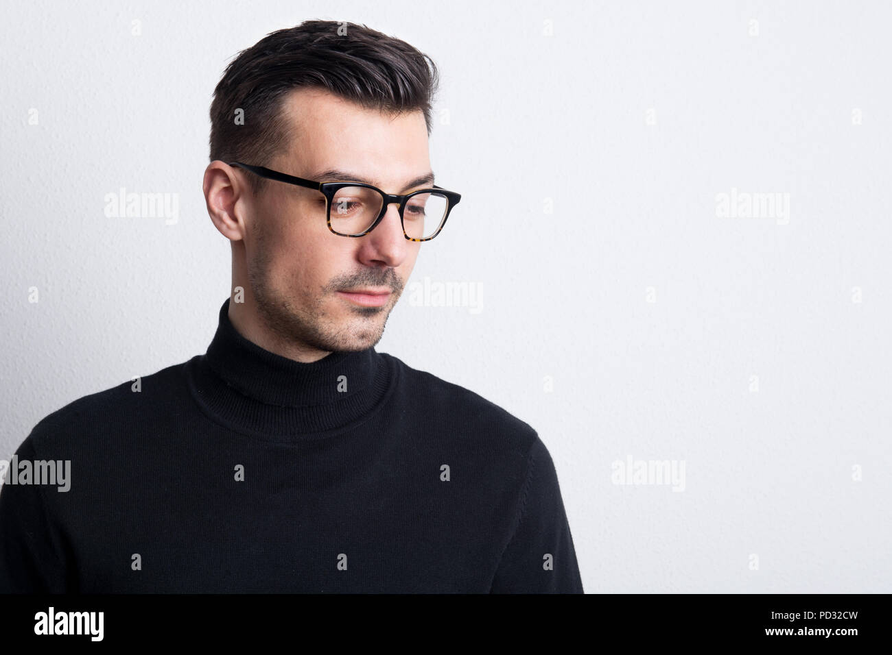 Portrait of a young man with glasses in a studio. Copy space Stock ...