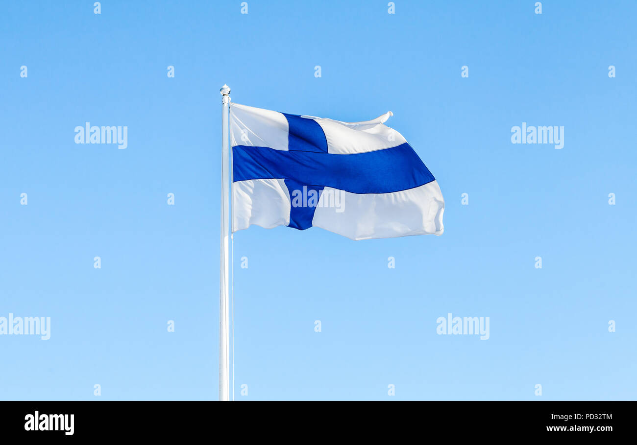 Flag of Finland, also called Blue Cross Flag over blue sky background Stock Photo