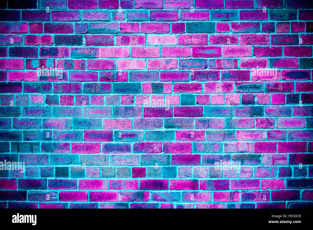 Close-up of brick wall with fuchsia, blue, purple, pink, ultra violet color and black brick; disco lights effect. Sargasso Sea - pantone Stock Photo