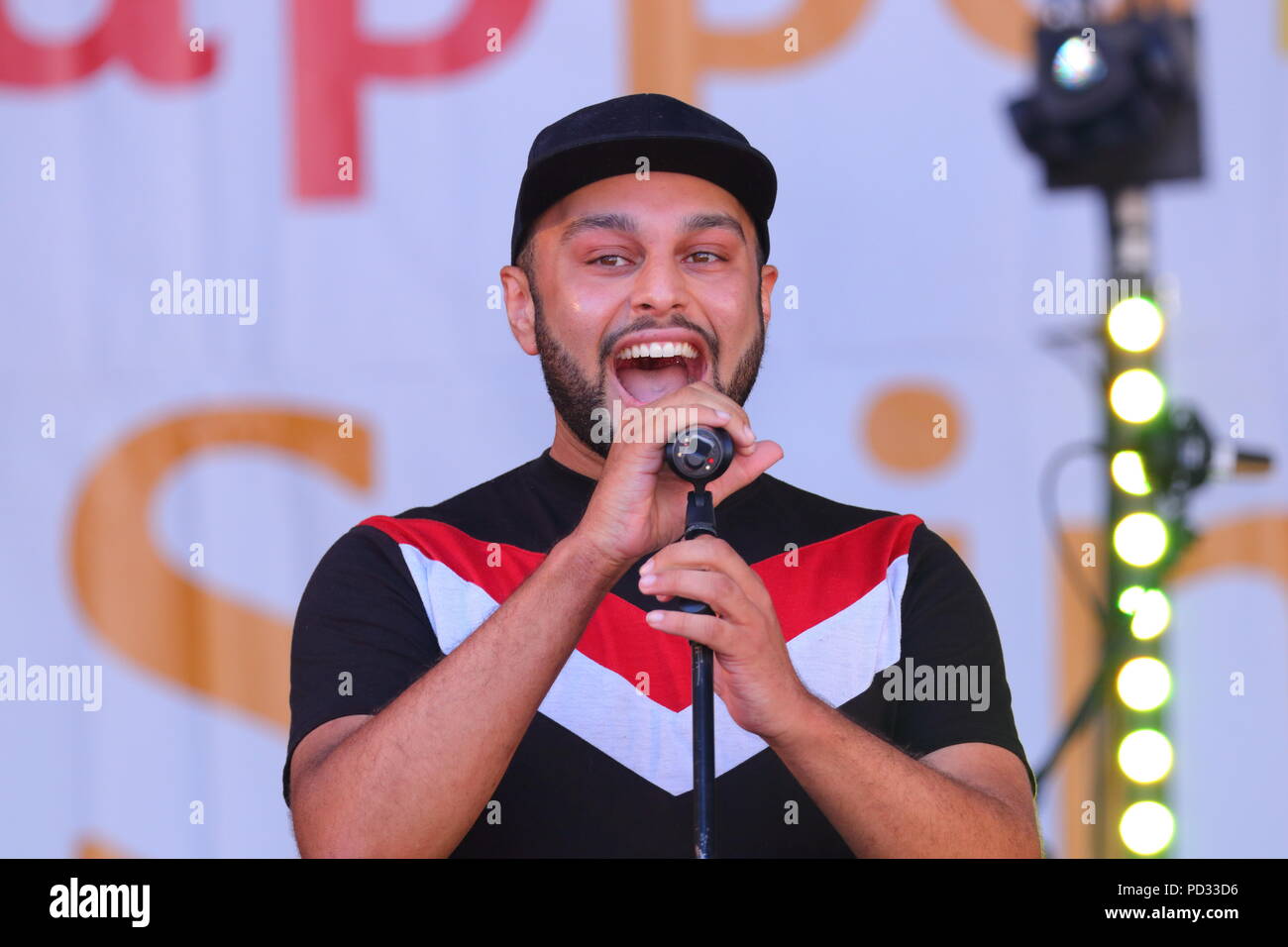 Corey Cooper is an up and coming artist from Birmingham and is seen here performing live on stage at Millennium Square in Leeds for the LGBT Pride Stock Photo