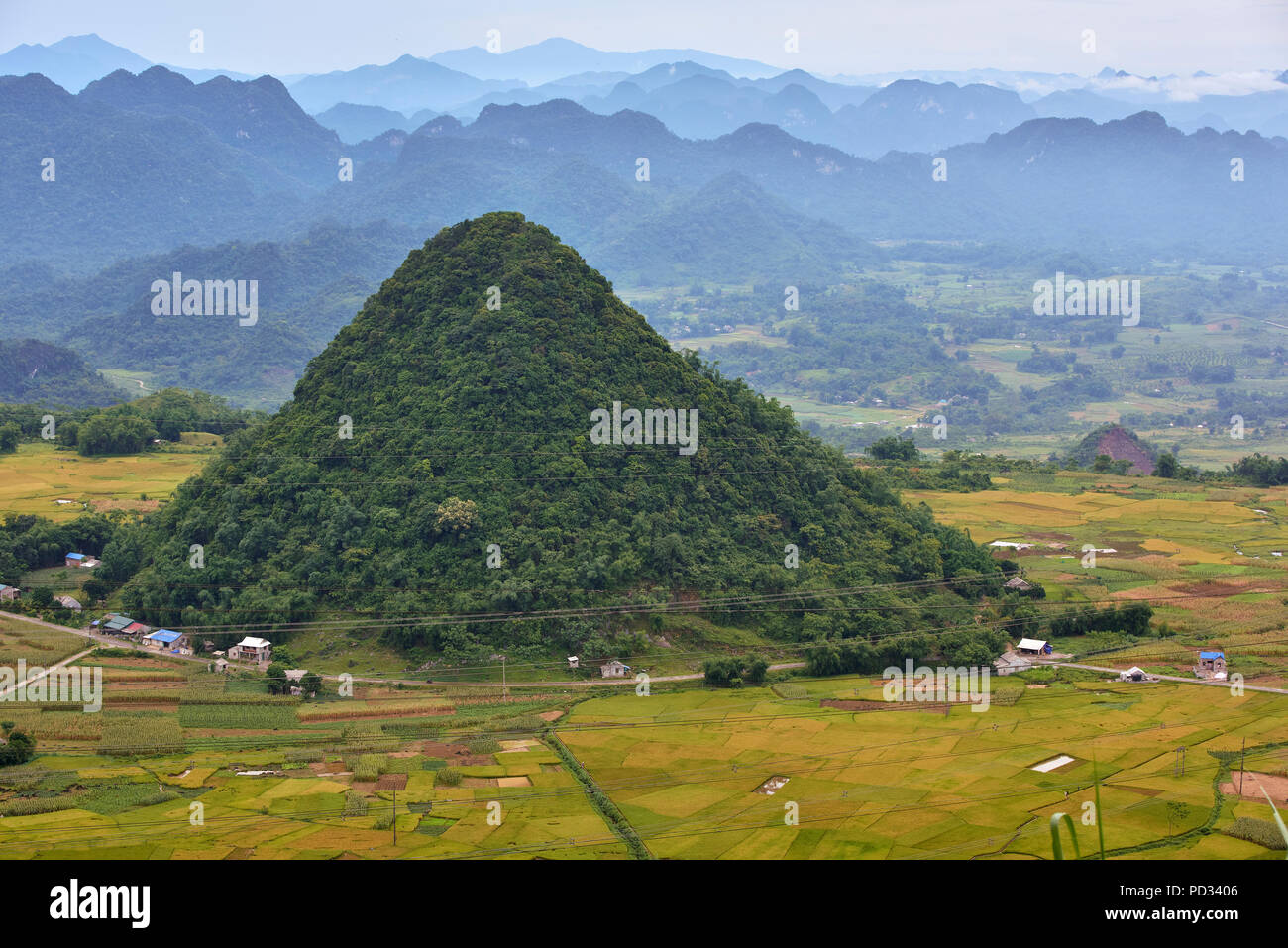 High angle shot of scenary in Hoa Binh region of North Vietnam, featuring montains with low hanging clouds and mist in the distance. Stock Photo