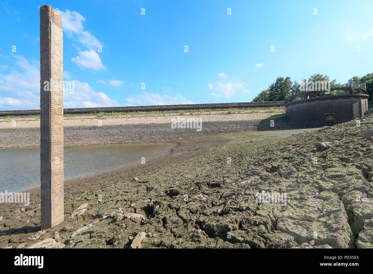 Wayoh Reservoir, Entwistle, Bolton, Lancs, UK. 5 August 2018. Wayoh Reservoir, Entwistle, Bolton, Lancs, UK.  The United Utilities reservoir is continuing to show very low levels, despite rain last weekend and cooler weather following the recent heatwave. Marker boards seem to indicate a water level 10 metres below normal levels. United Utilities had planned to introduce a hosepipe ban on Sunday 5 August 2018, but called it off at the last minute citing improved  water levels and colder weather. Credit: Phil Taylor/Alamy Live News Stock Photo