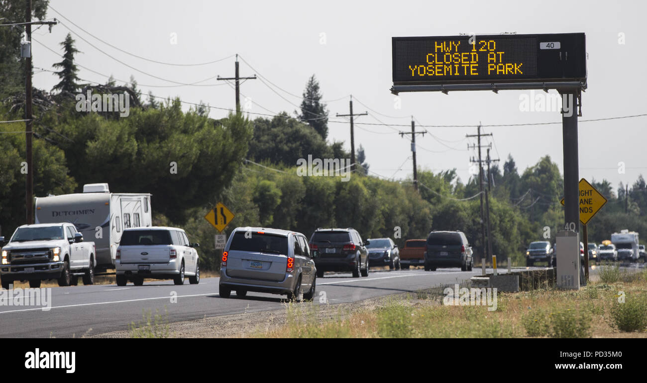 Oakdale, California, U.S.A. 5th Aug, 2018. A Caltrans sign near Oakdale CA advises travelers that Highway 120 is closed going towards Yosemite National Park due to a wildfire. The Ferguson Fire in Mariposa County California continues to burn causing heavy smoke in the park. Credit: Marty Bicek/ZUMA Wire/Alamy Live News Stock Photo