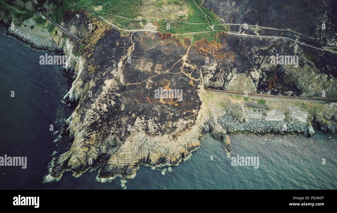 Dublin. 6th Aug, 2018. Photo taken with drone on Aug. 5, 2018 shows a sign of a word 'EIRE' which stands for Ireland in Irish and a number of eight on a burned hill in Bray, a town some 40 km south of Dublin, Irland. The sign, built with stones during the World War II for navigating and alerting pilots, was revealed on Saturday after the hill caught a wildfire due to a recent heatwave in Ireland. Credit: Xinhua/Alamy Live News Stock Photo