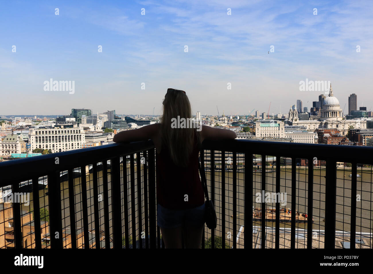 London UK. 6 August  2018. A visitor admires the view of London city skyline and financial district from the 10th floor viewpoint at Tate Modern on another hot day as temperatures are expected to exceed 30C Credit: amer ghazzal/Alamy Live News Stock Photo
