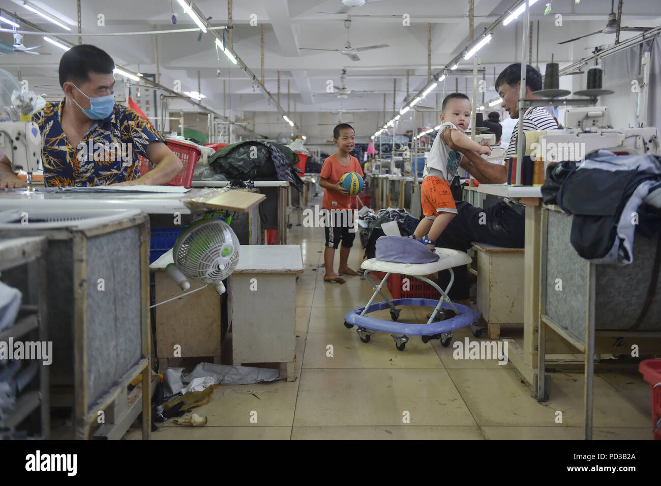 Shishi China S Fujian Province 31st July 18 A Child Is Taken Care By His Grandfather At A Clothing Factory In Shishi City Southeast China S Fujian Province July 31 18 Shishi A Well Known Shishi China S Fujian Province 31st July 18 A Child Is Taken Care By His Grandfather At A Clothing Factory In Shishi City Southeast China S Fujian Province July 31 18 Shishi A Well Known