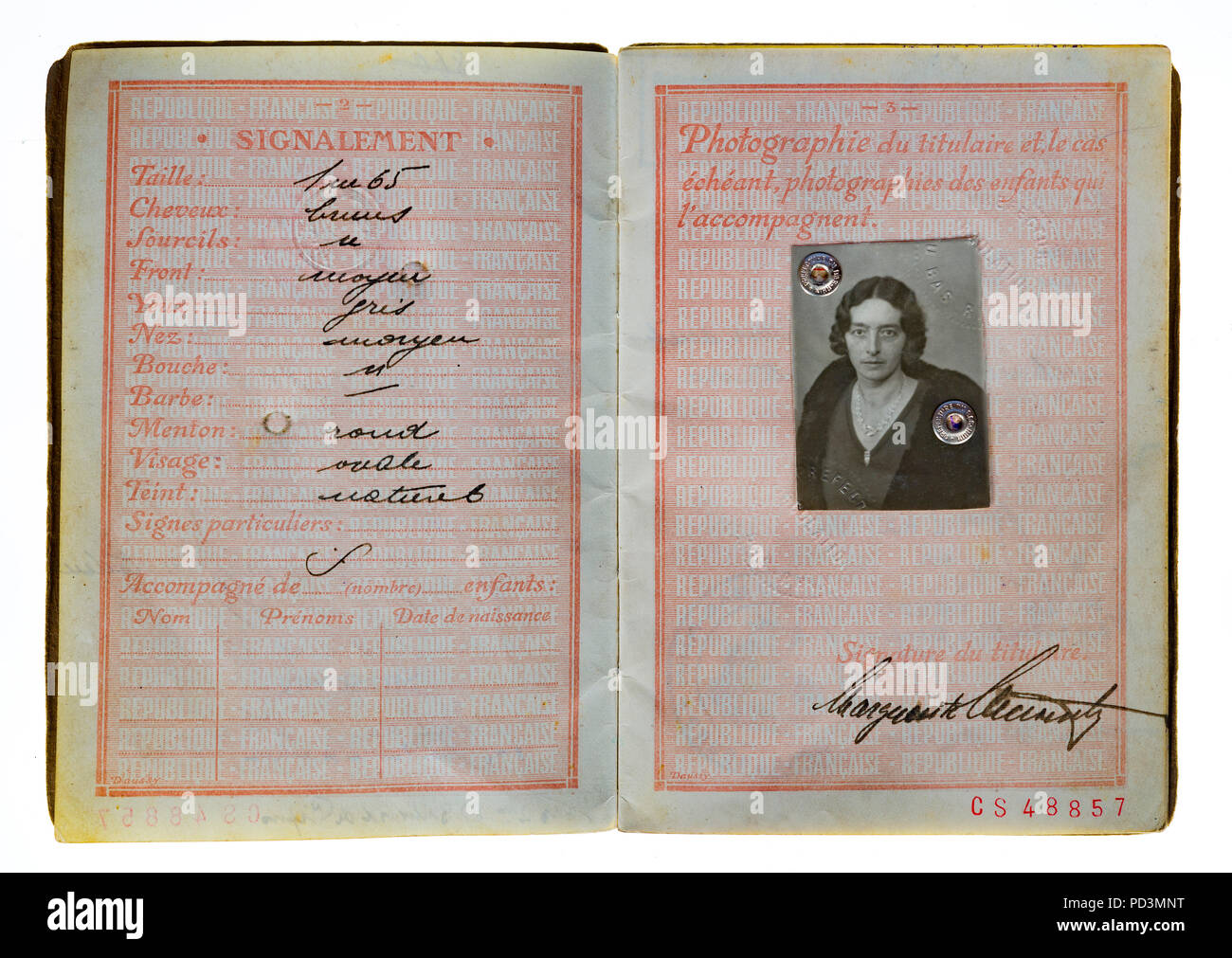 1935's vintage French passport, pages with holder description and woman photograph, Stock Photo