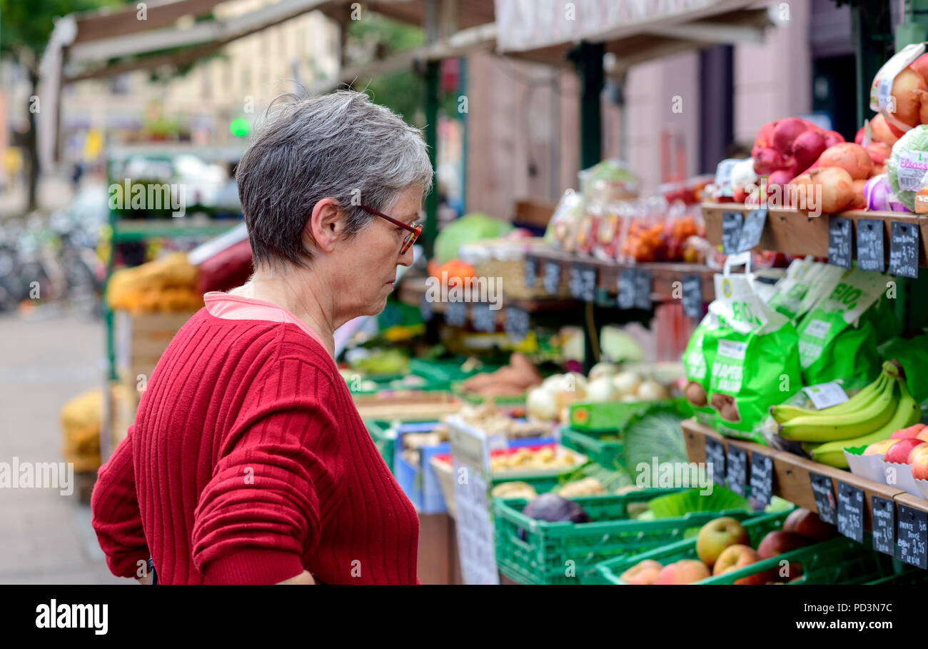Senior woman shopping for fruits at grocery stall, Strasbourg, Alsace, France, Europe, Stock Photo