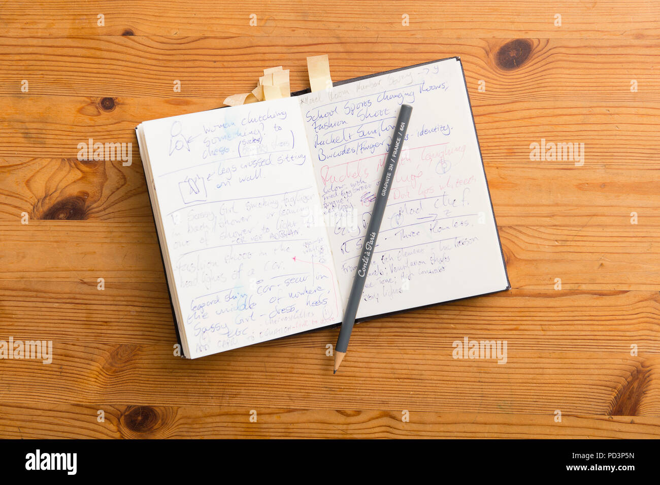 Top down view of notebook and pencil on tabletop Stock Photo