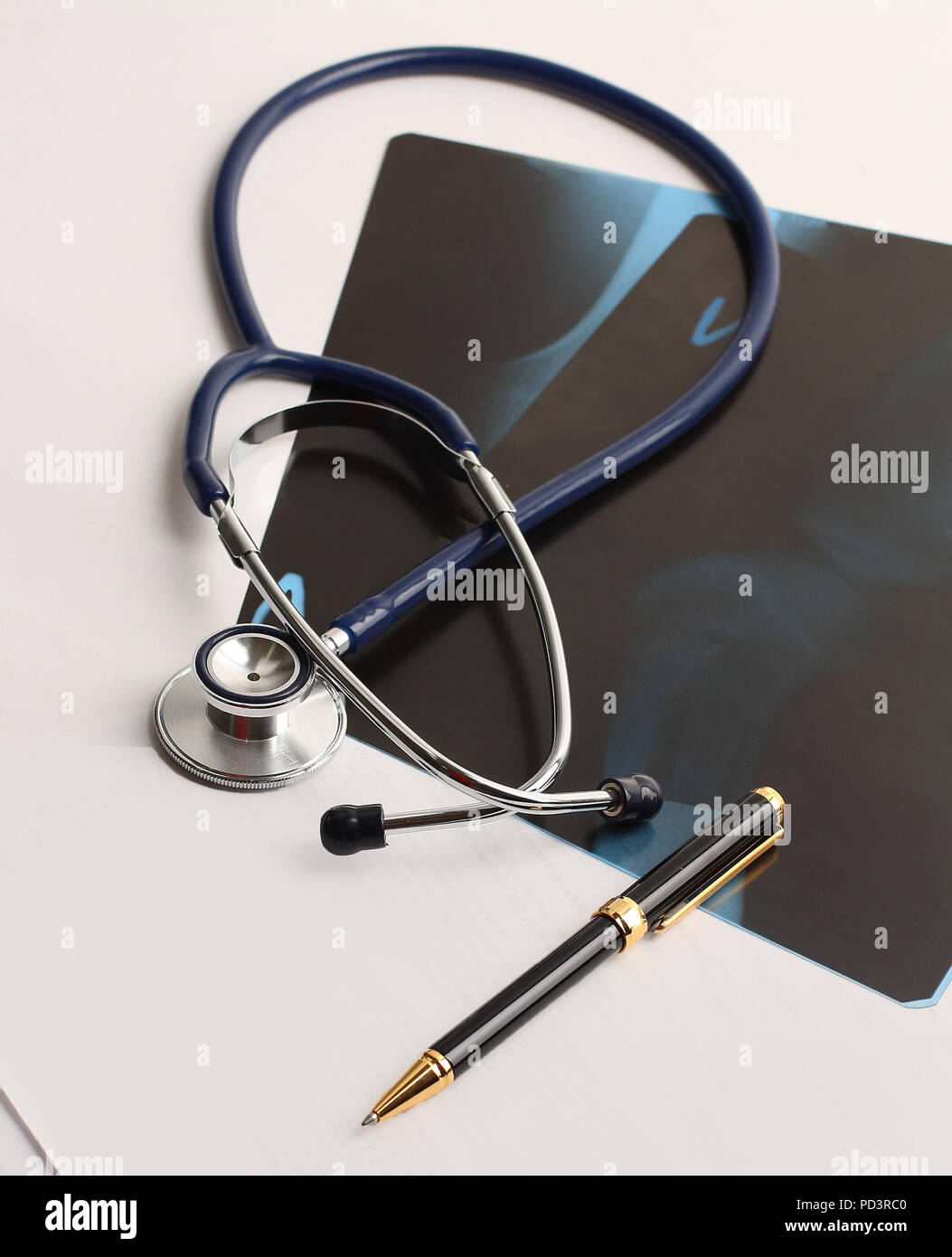 stethoscope,x-ray and pen on the table. Stock Photo