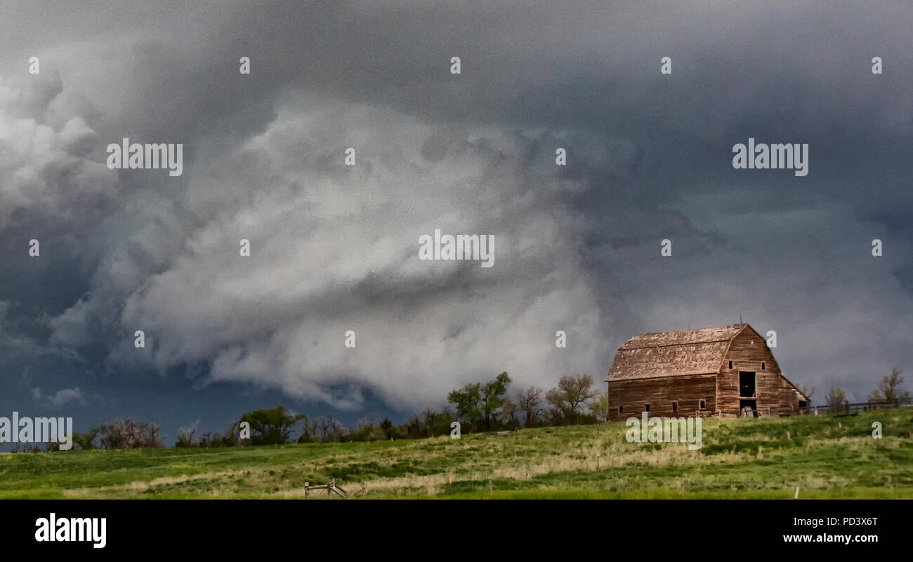 Mesocyclone as rotating thunderstorm, barn in foreground, Chugwater, Wyoming, US Stock Photo