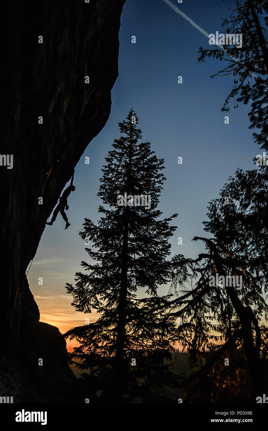 Silhouette of rock climber rock climbing at sunset, Flagstone, Eugene