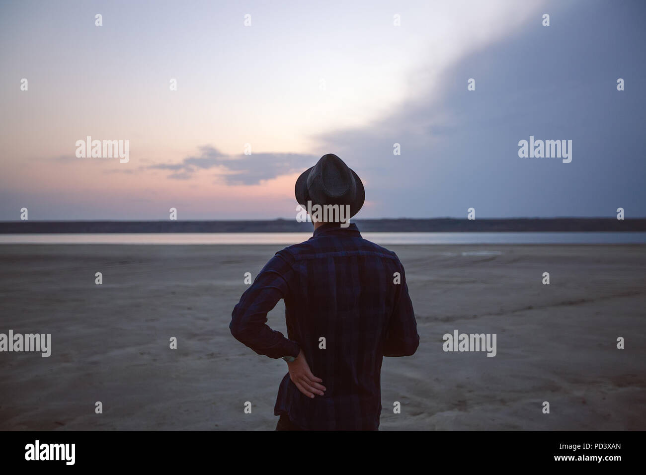 Man in hat on beach at sunset, Odessa, Ukraine Stock Photo