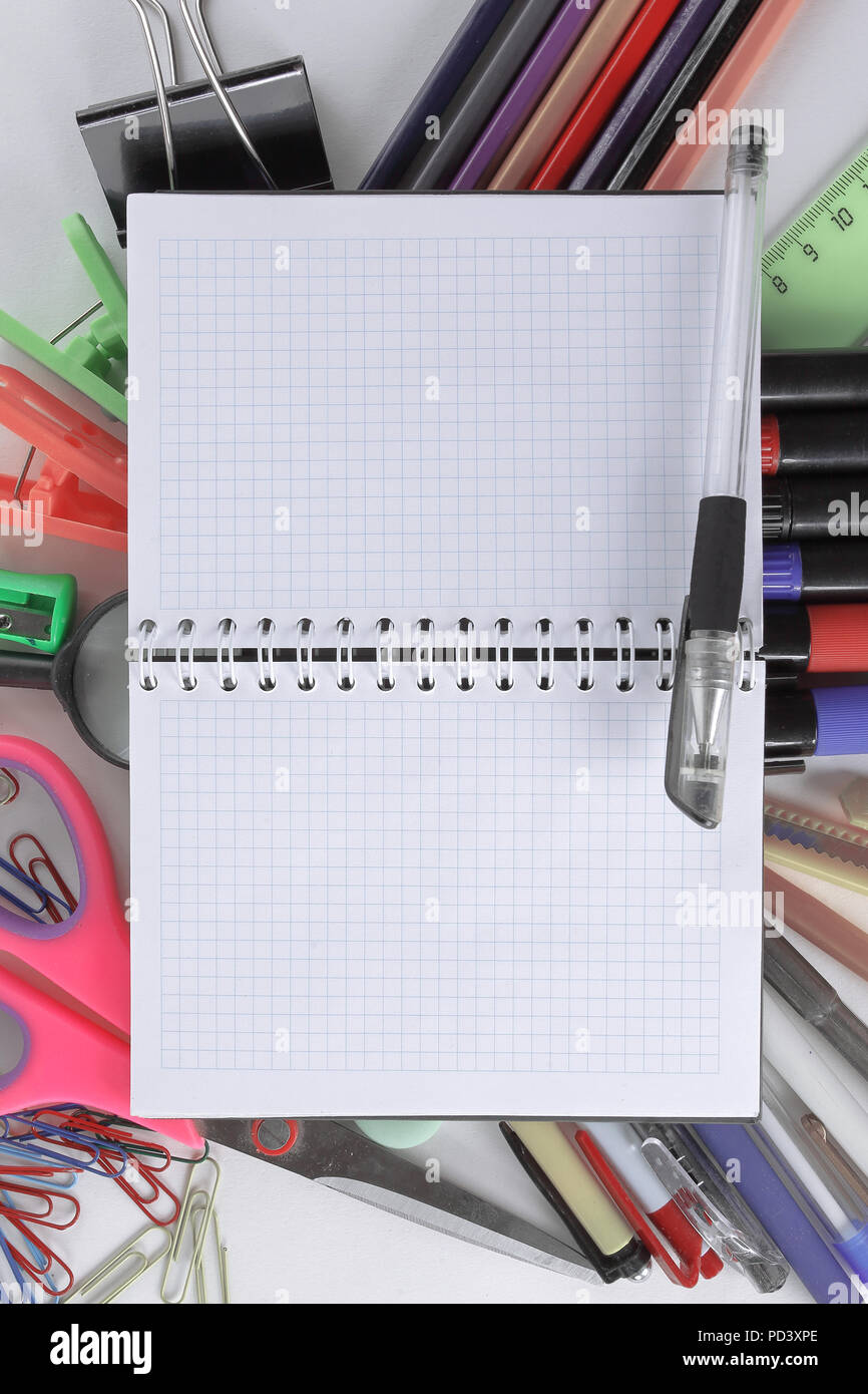 opened Notepad on office supplies on white background Stock Photo