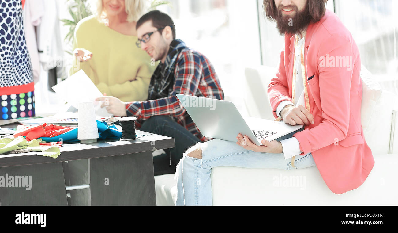 stylish designer and colleagues in the creative workshop Stock Photo