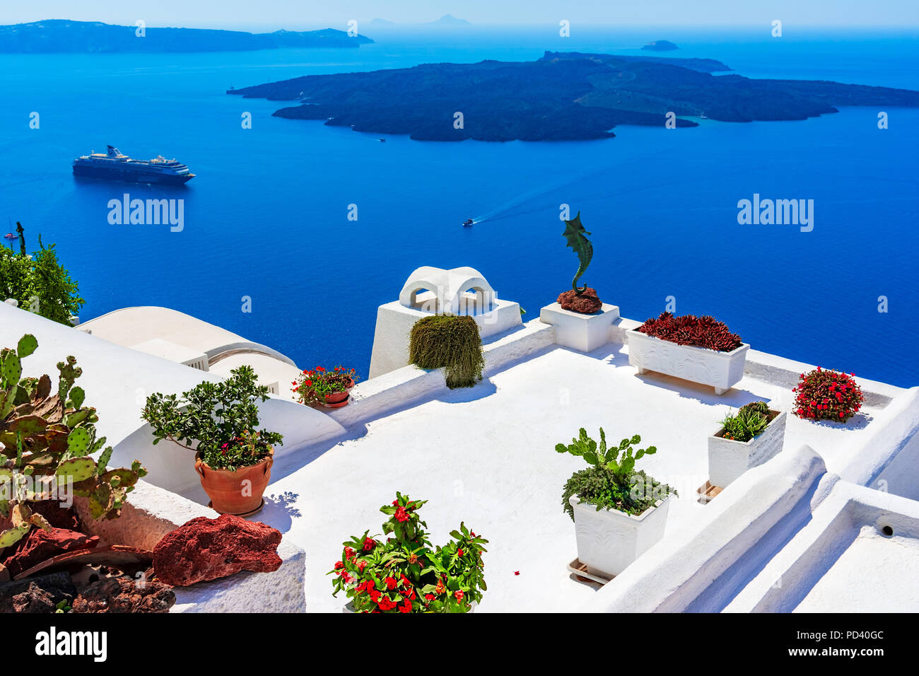 Santorini island, Greece: Landmark detail of a terrace decorated with flowers over the caldera Caldera Stock Photo